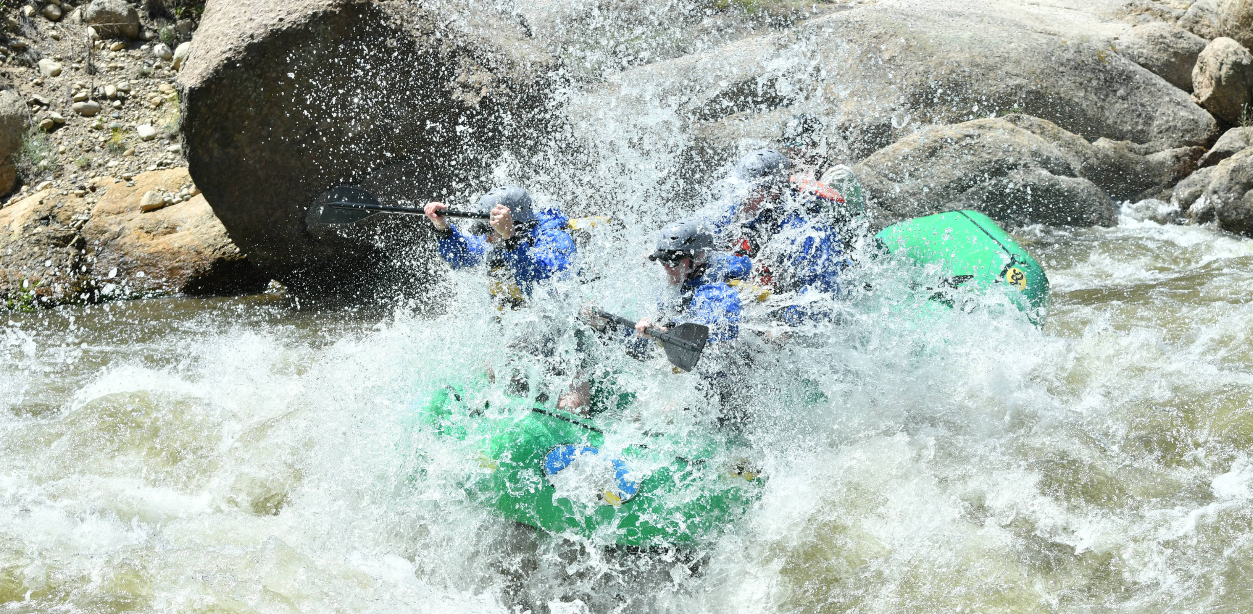 A green raft hits a large rapid on the browns canyon section of the arkansas river