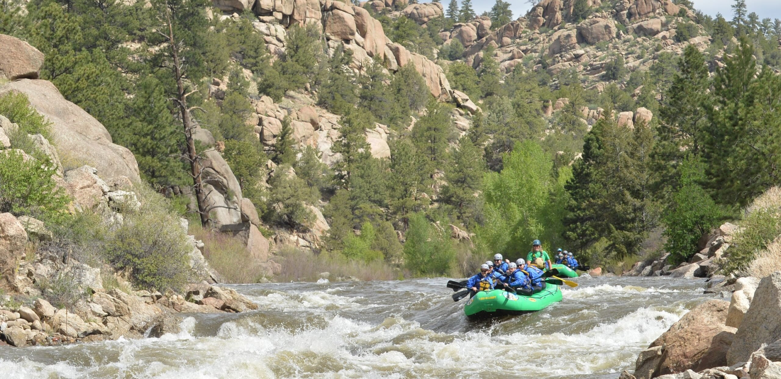 Rafting groups paddling into rapids on a Browns Canyon river rafting trip.