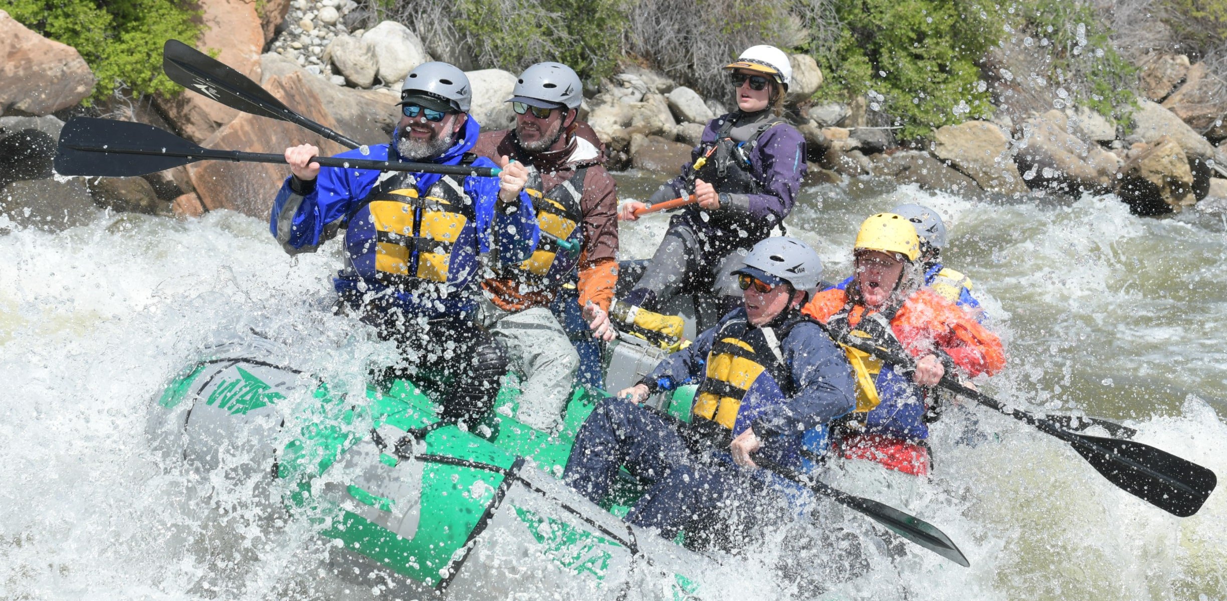 a group rafting in whitewater rapids in Colorado