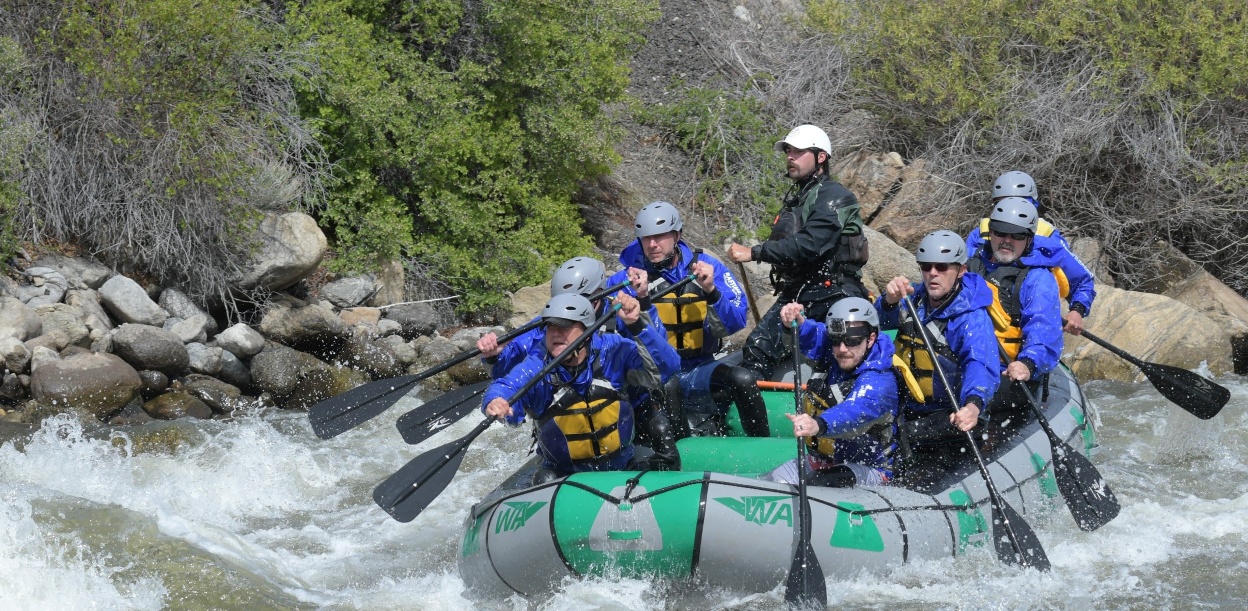 a group rafting in whitewater rapids in Colorado