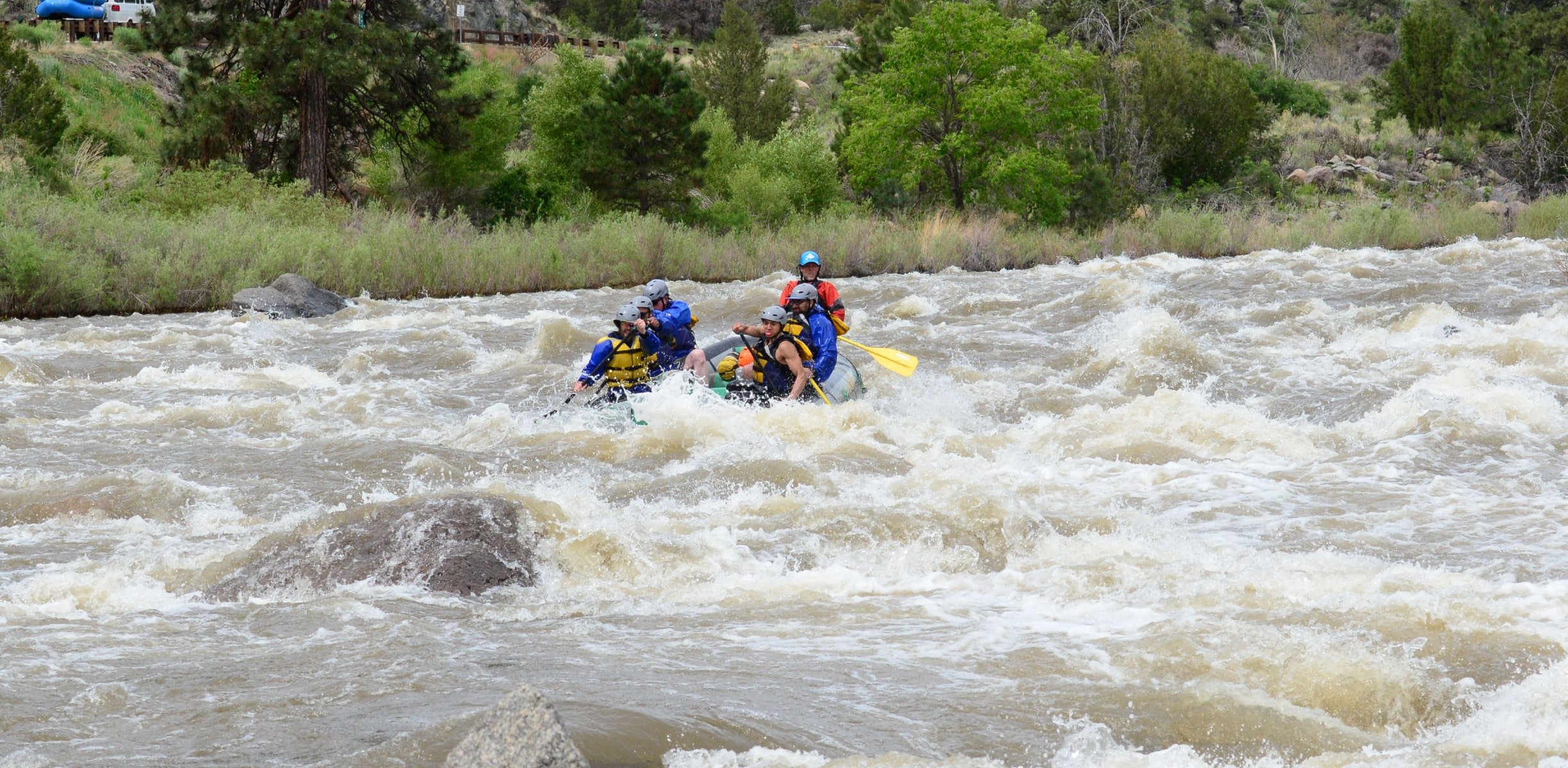 a group rafting in whitewater rapids in Colorado