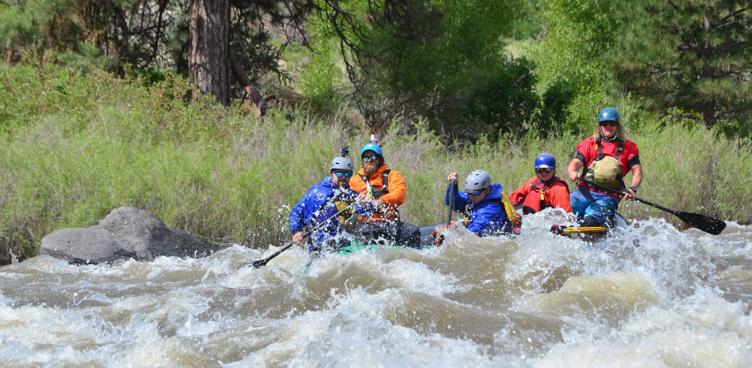 a group rafting in whitewater rapids in Colorado