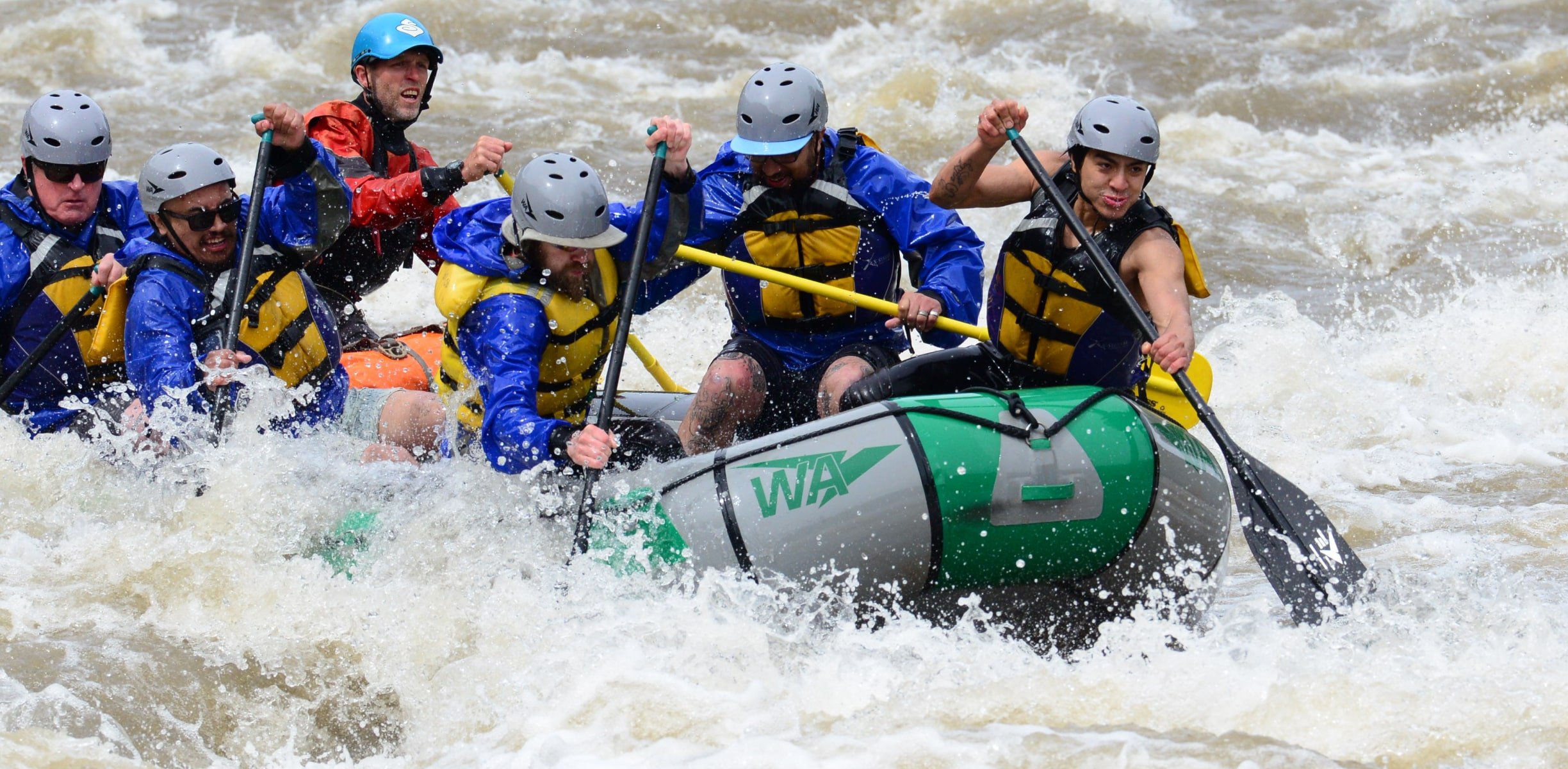 a group rafting in whitewater rapids in Colorado