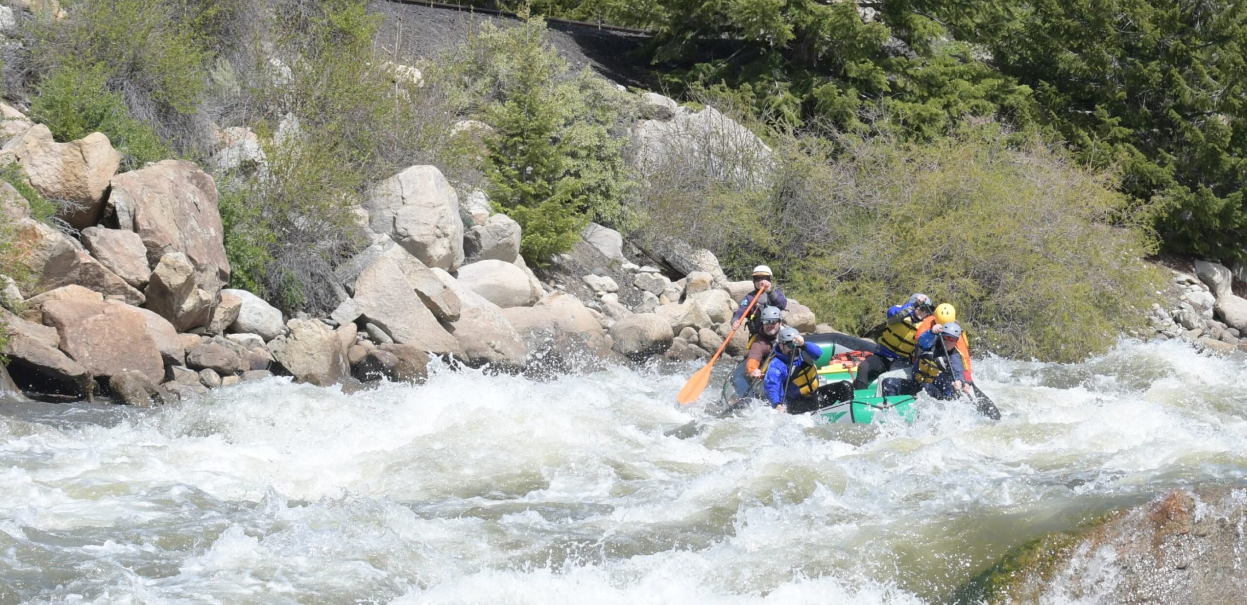 a group rafting in whitewater rapids in Colorado