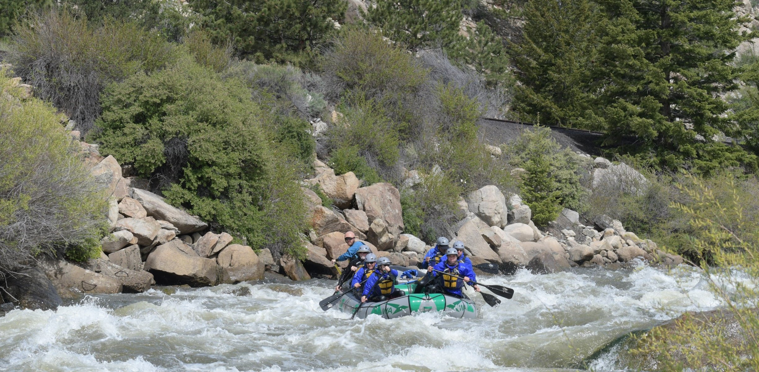 a group rafting in whitewater rapids in Colorado