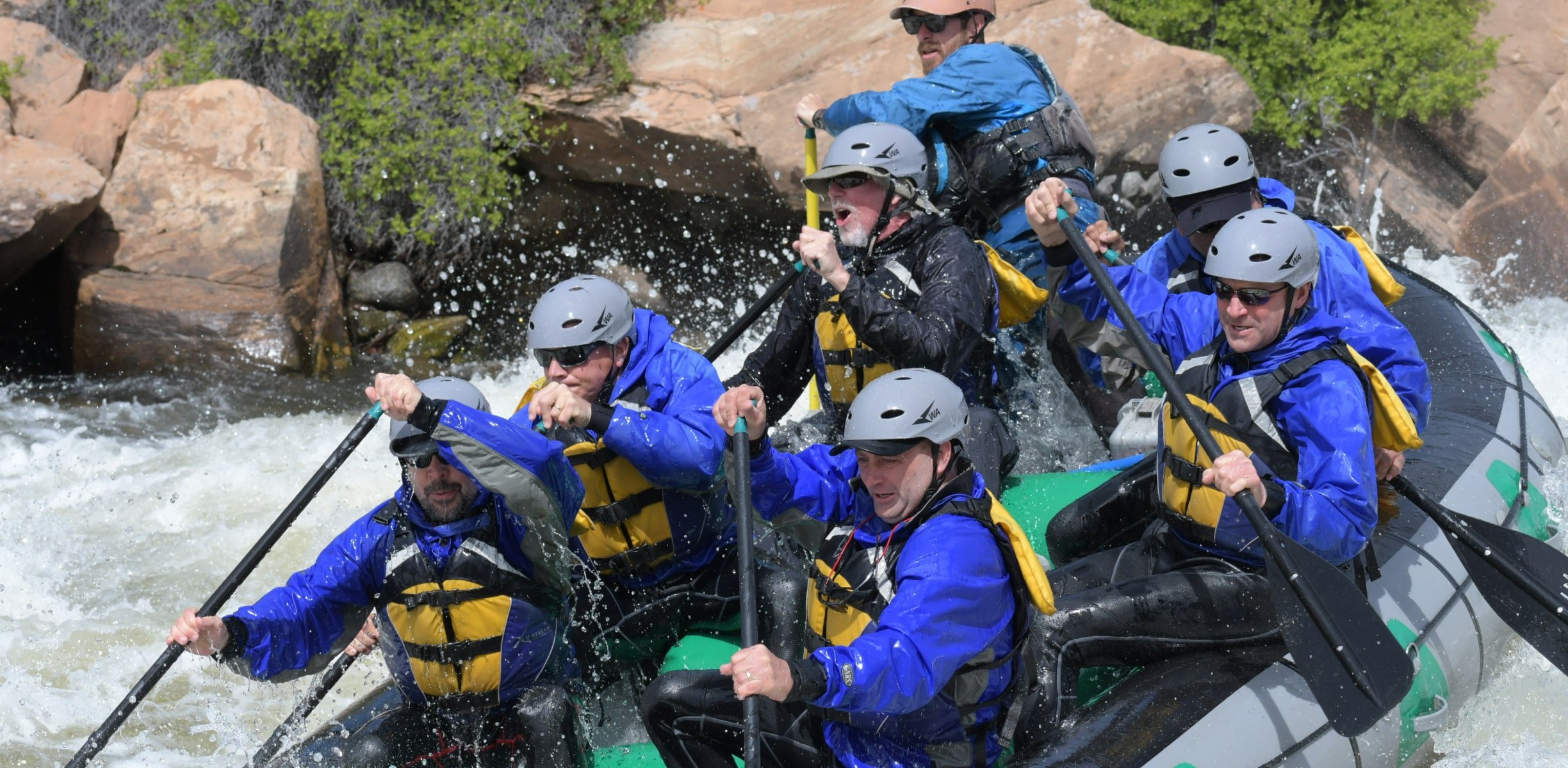 a group rafting in whitewater rapids in Colorado