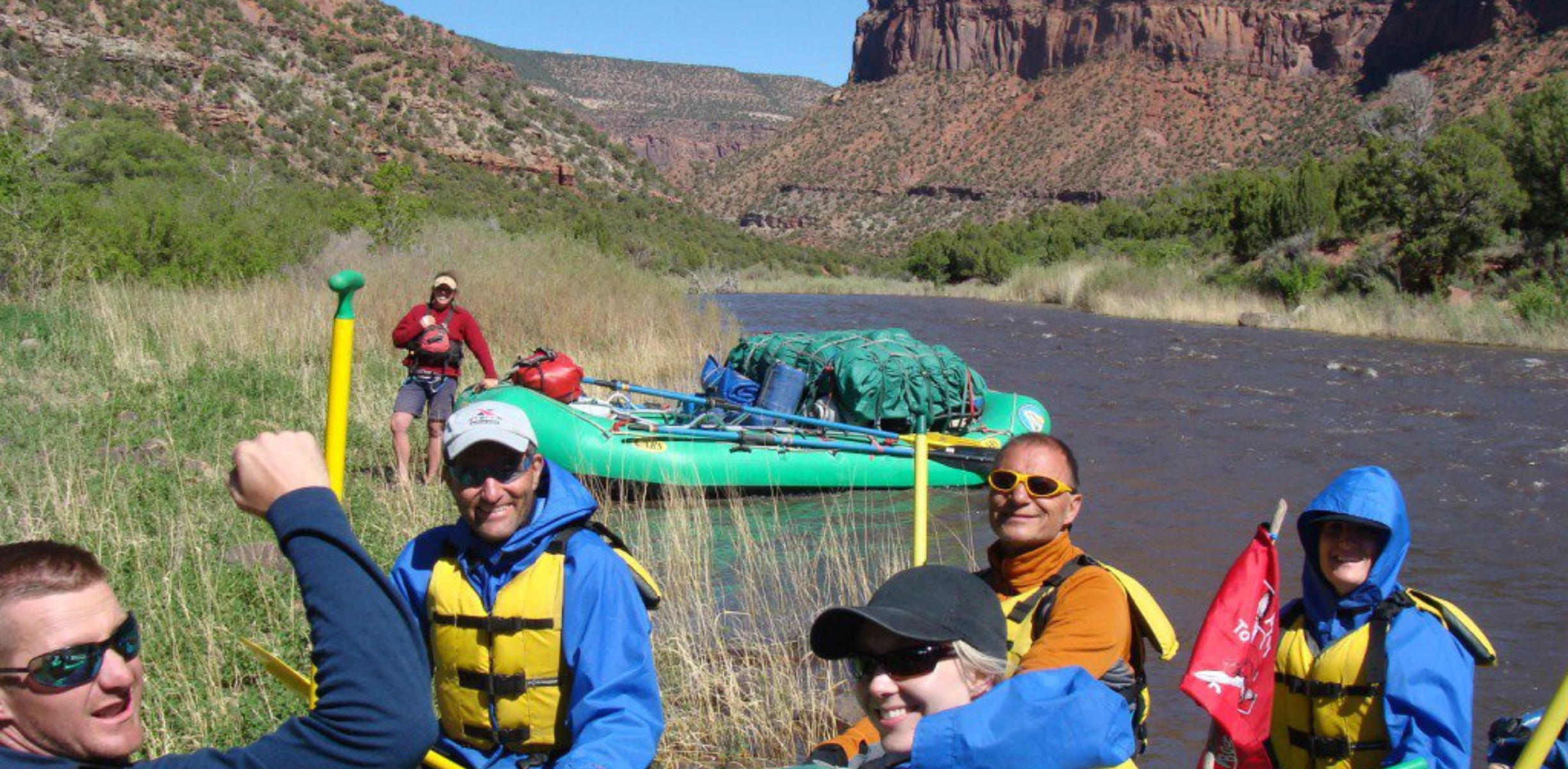 People on rafts on the Dolores River smile