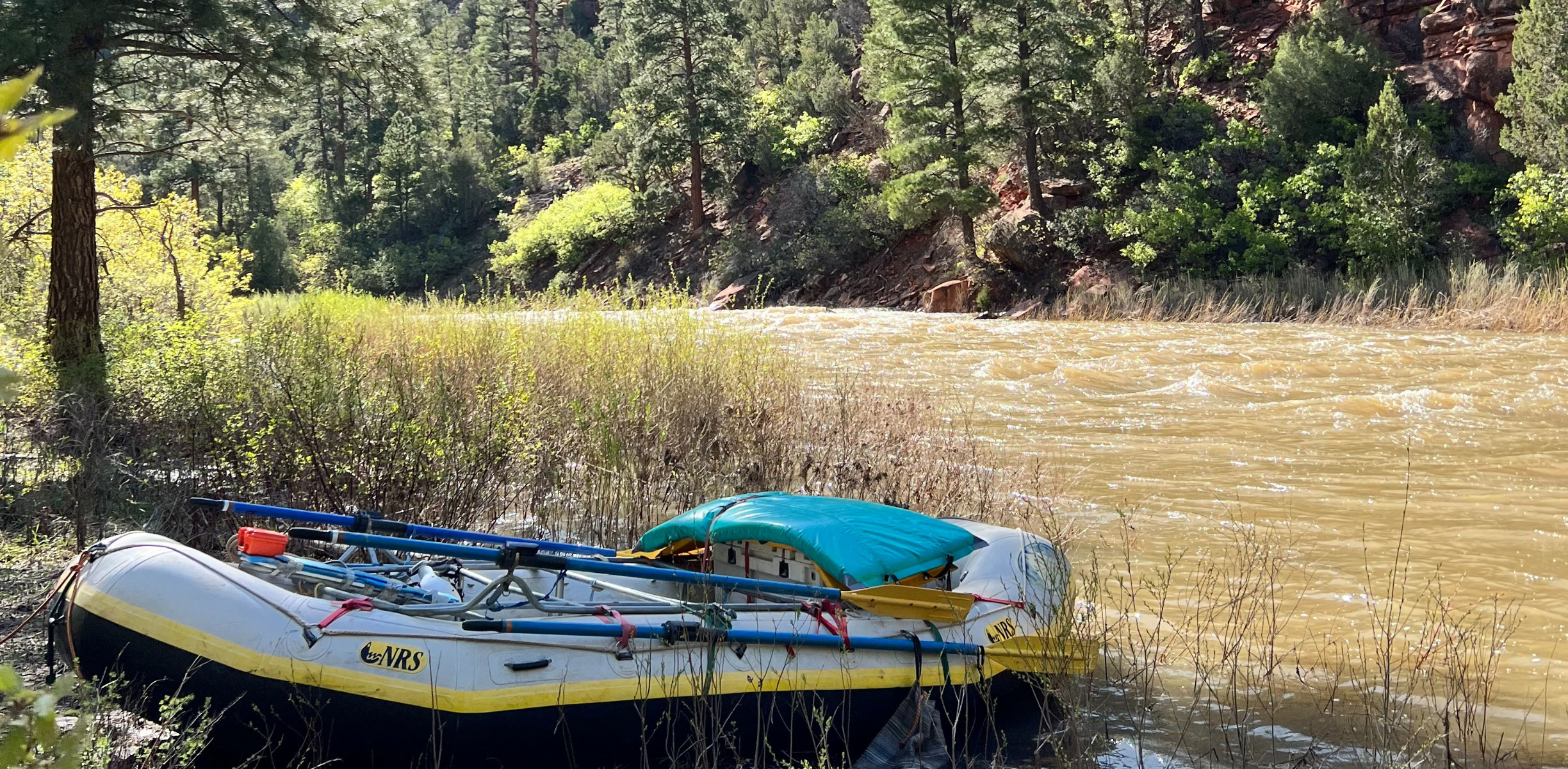 A raft sits on the shore of the Dolores River