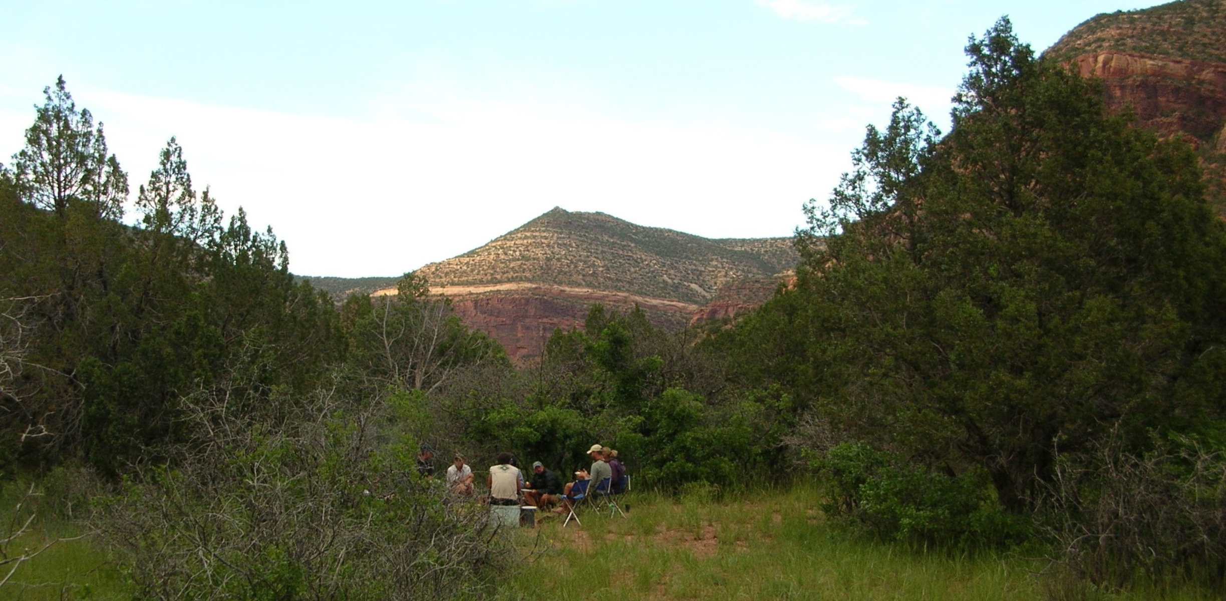 People sit in chairs at camp during a dolores rafting trip