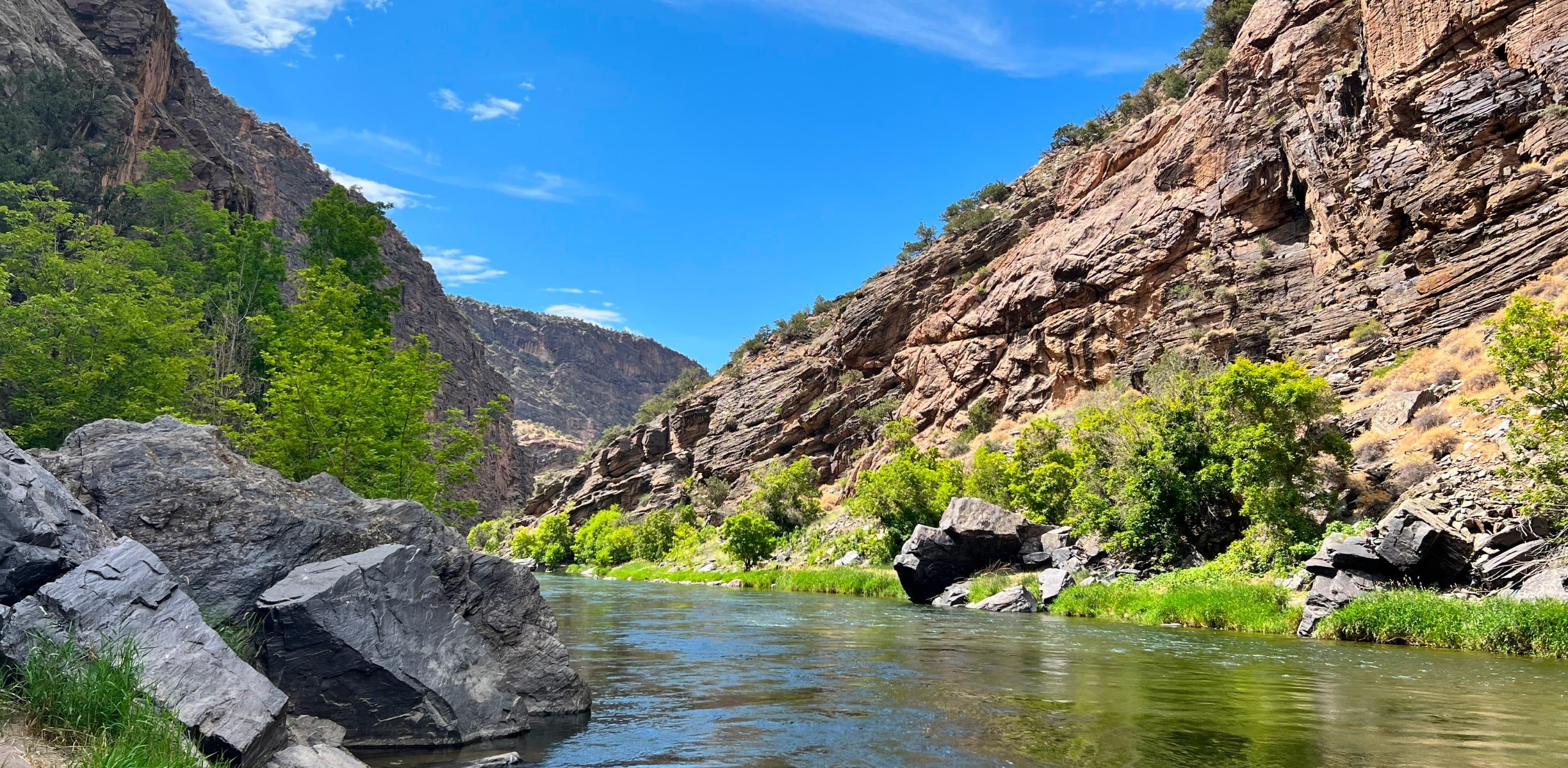 A scenic shot of the Gunnison river on a blue sky day