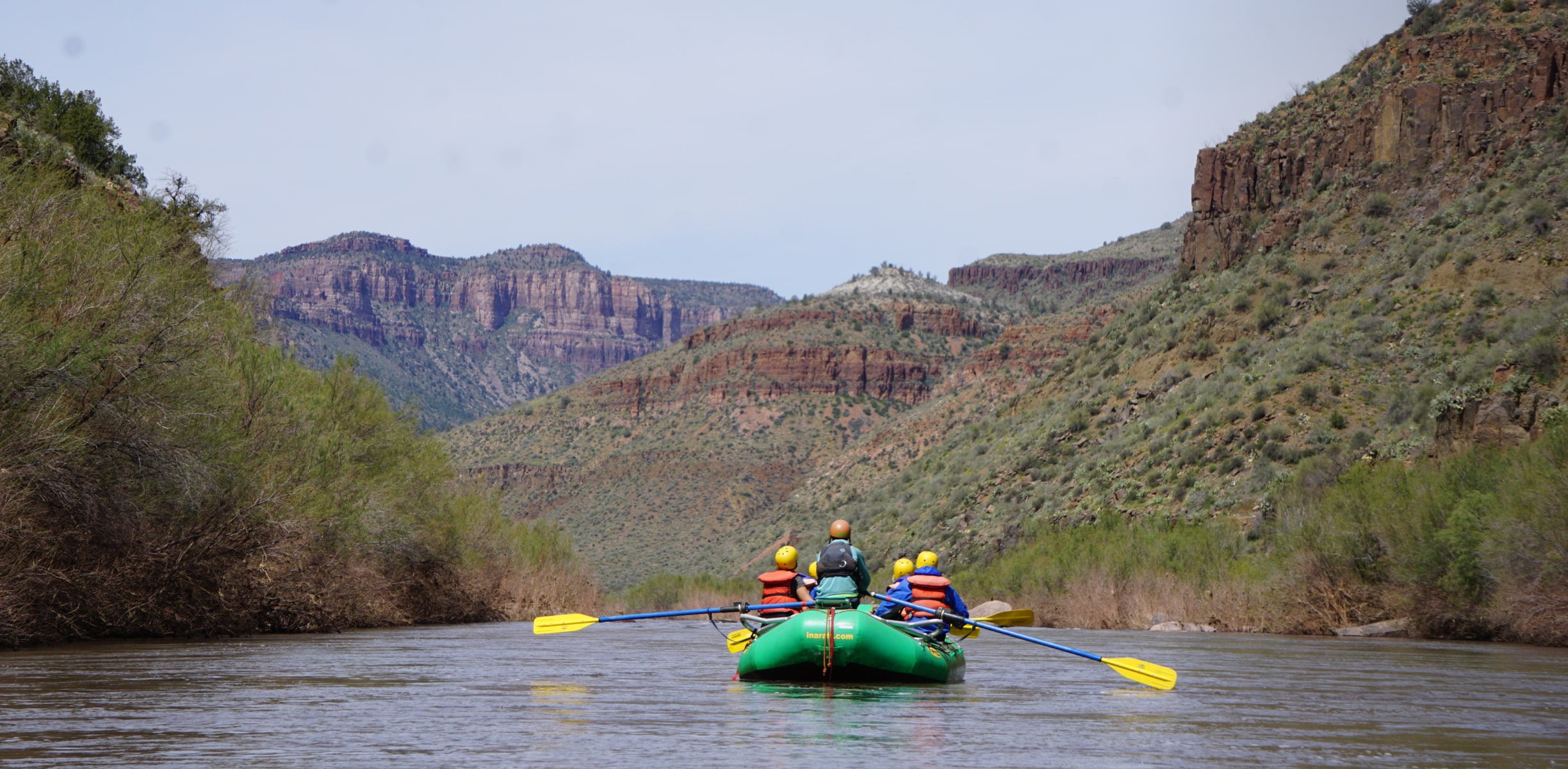 A group of white water rafters hitting a set of rapids in Arizona