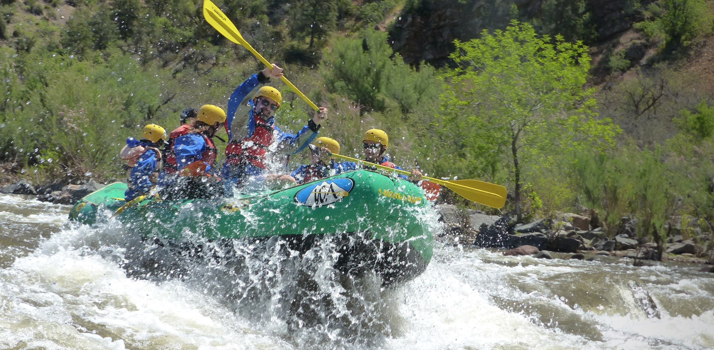 A group of white water rafters hitting a set of rapids in Arizona