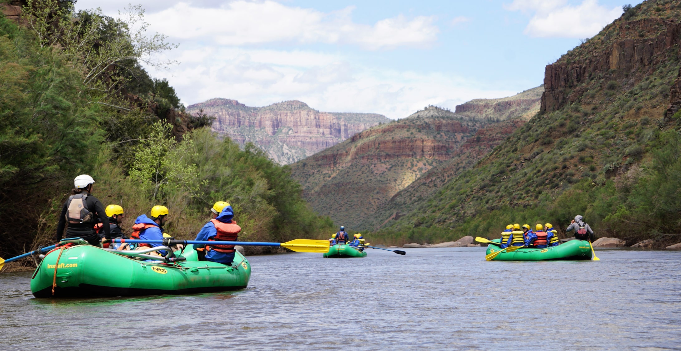 A group of white water rafters paddle a mellow stretch of the Salt River in arizona