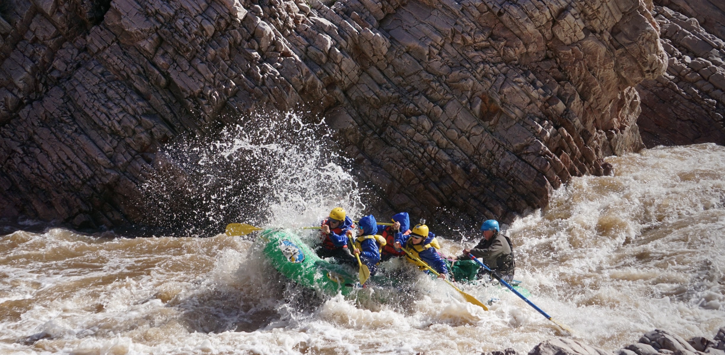 A group of white water rafters hitting a set of rapids in Arizona