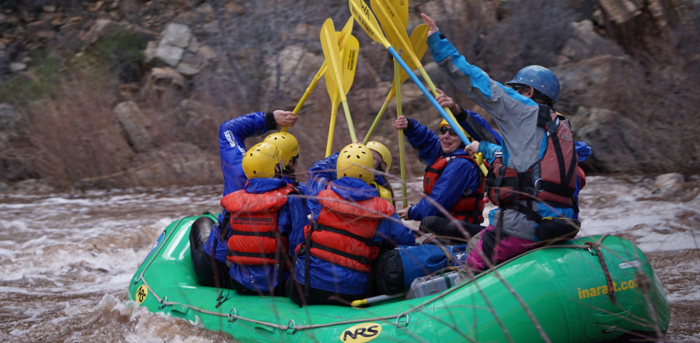 A group of white water rafters hitting a set of rapids in Arizona