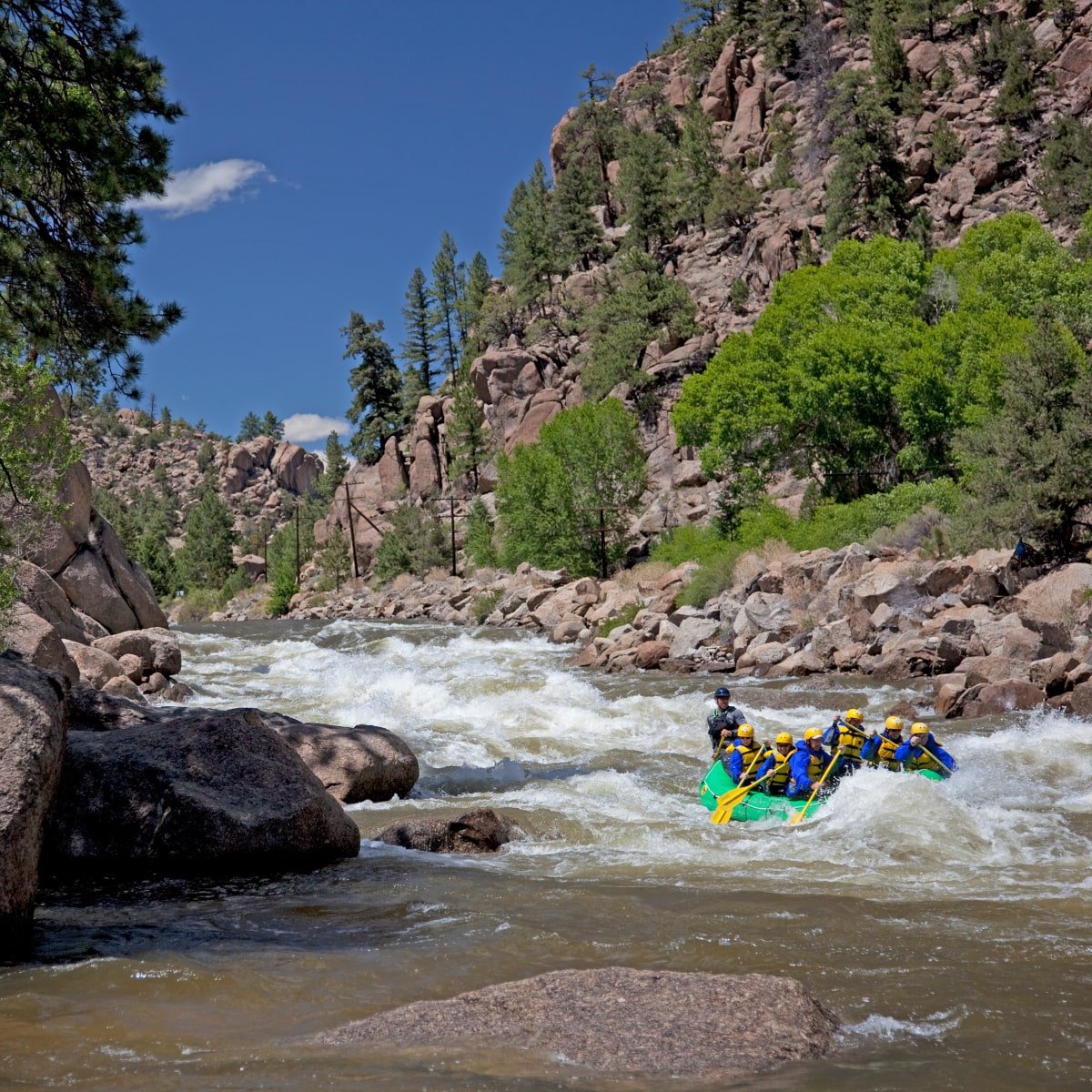 A group of white water rafters hitting a set of rapids